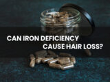 Jar full of iron pills in the background with a text "Can iron deficiency causes hair loss?" front.