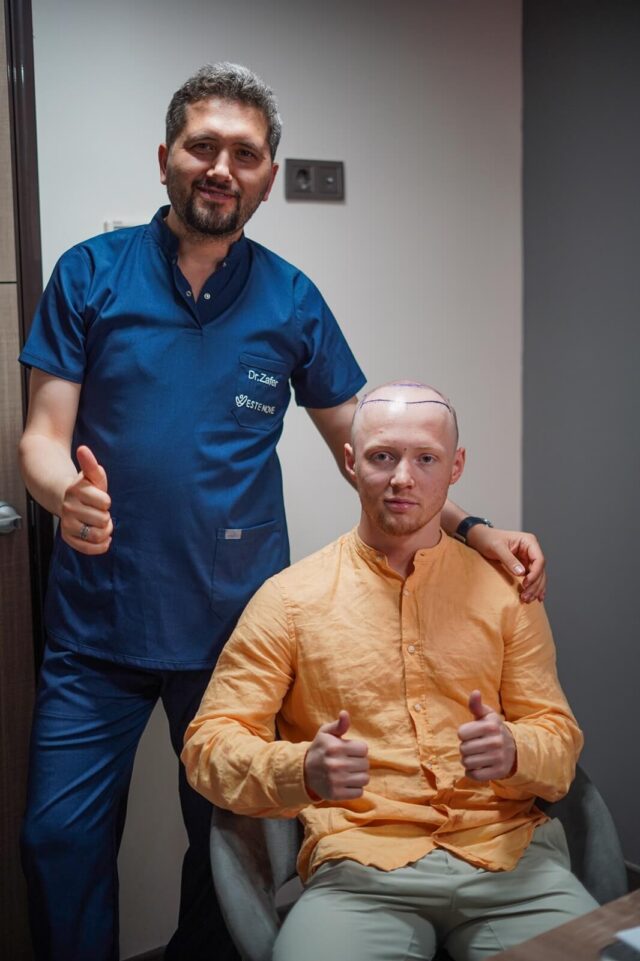 Patient posing with doctor before the hair transplantation procedure